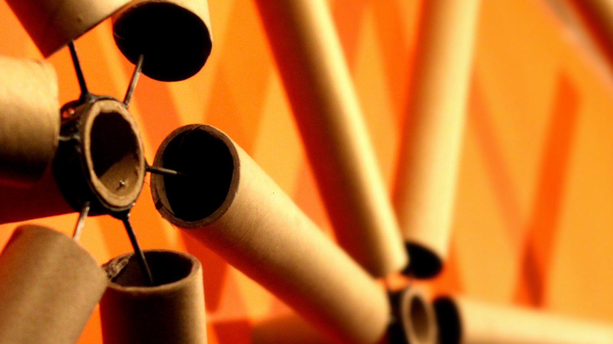 Cover photograph: close-up of orange cardboard tubes joined into a structure