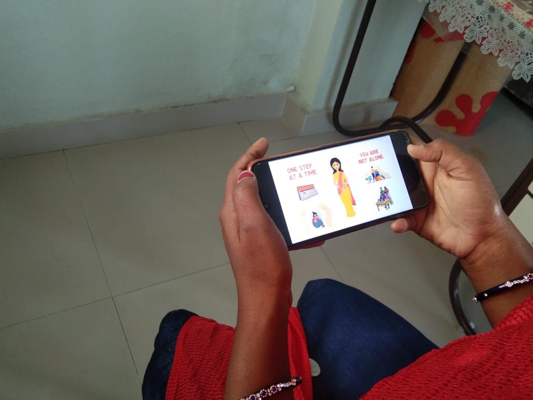 A woman watching an episode of the series on her phone